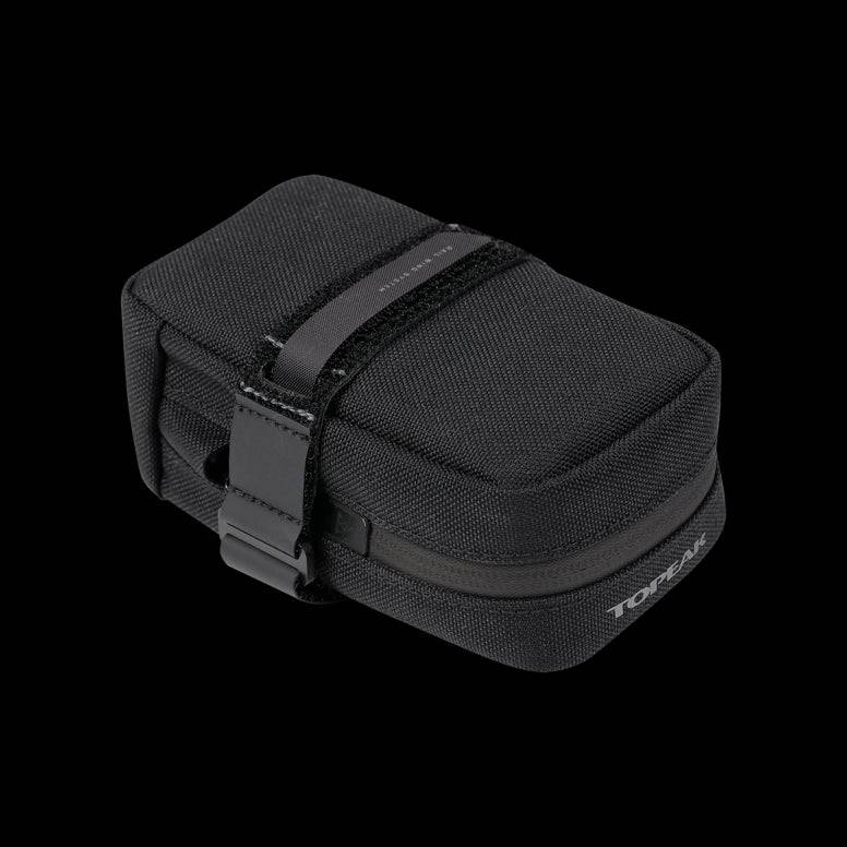 Topeak Elementa seatbag attached to a bike saddle, compact bike saddle bag for tools and inner tubes, black accessory for cycling.
