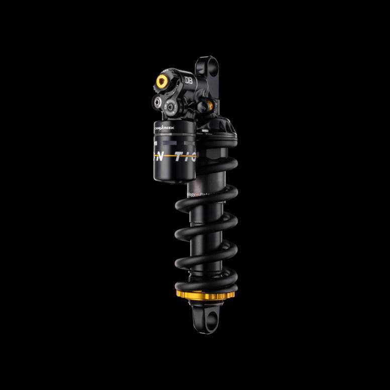 Cane Creek Tigon Coil Rear Shock with RAMP Tube Technology for trail bikes, showcasing the suspension component with coil spring and branding.