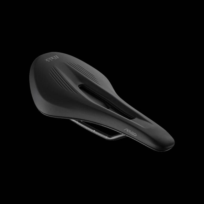 Fizik Vento Argo X3 off-road racing saddle with ergonomic cut-out and mud flap, designed for mountain biking and gravel riding.