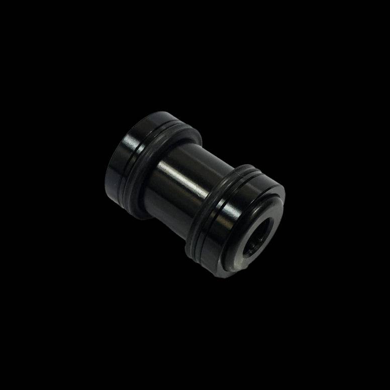 Cane Creek Double Barrel damper mounting hardware for rear shock, metal components with mounting bolts and spacers.