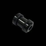 Cane Creek Double Barrel damper mounting hardware for rear shock, metal components with mounting bolts and spacers.