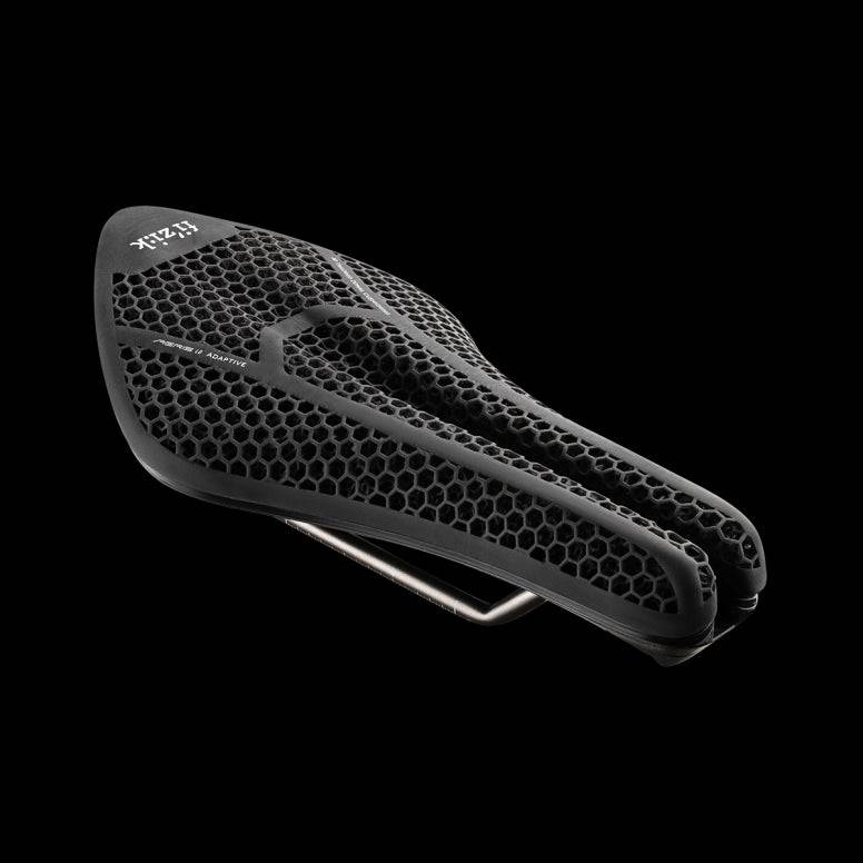 Fizik Transiro Aeris Adaptive R3 long-distance triathlon saddle in black, designed for comfort and performance on bike components.