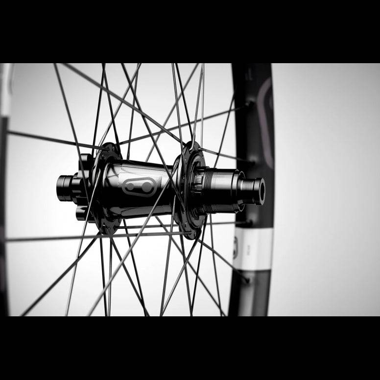 Crankbrothers Synthesis E11 Carbon MTB rear wheel mounted on a mountain bike, showcasing lightweight carbon rims and durable components.