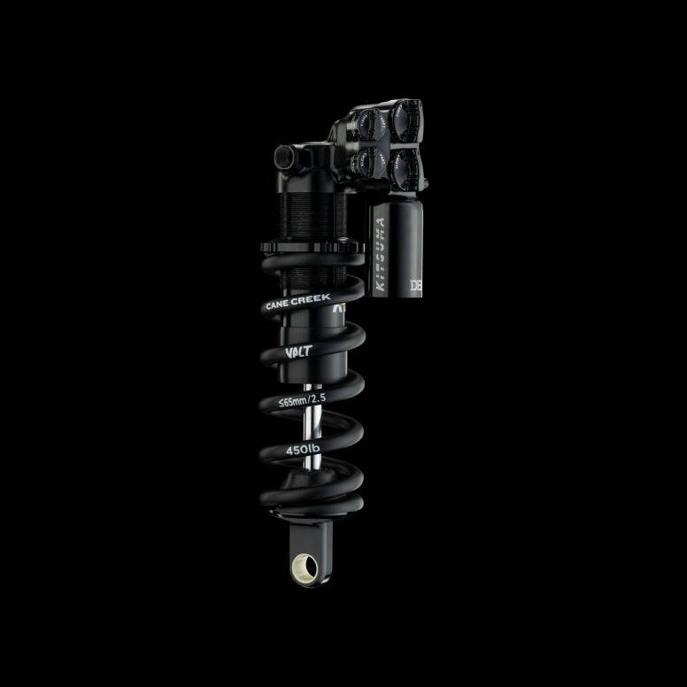 Cane Creek G2 Kitsuma Coil Trunnion Shock for downhill mountain bikes, showing the coil spring and shock body with mounting hardware.