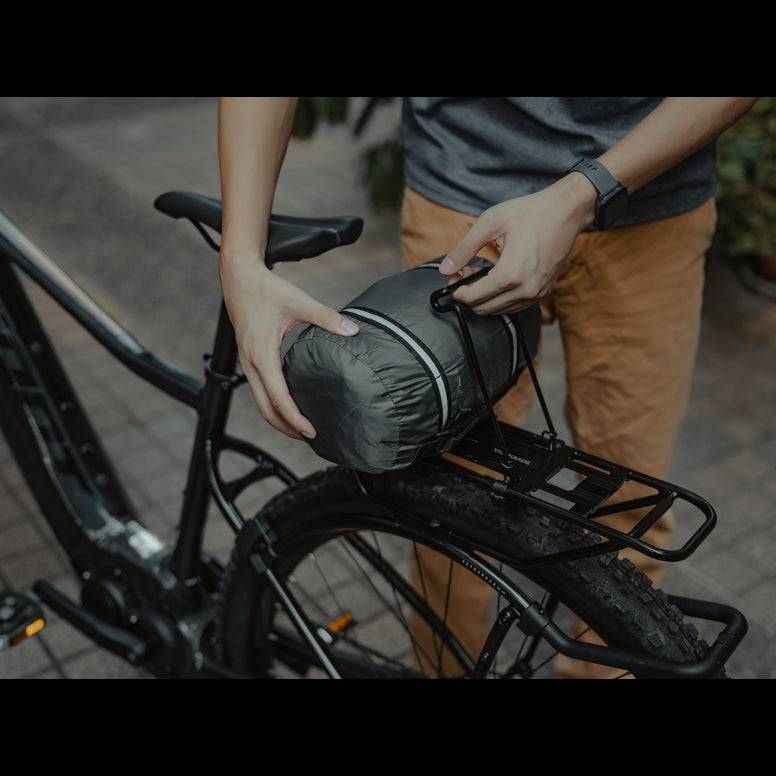 Black Topeak spring clip accessory for Tetrarack M2, M2L, and M2 HD bike racks, shown attached to the rack.