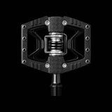 Crank Brothers Double Shot 3 hybrid clipless and flat pedal with adjustable cleats, shown from a side view on a bike component.