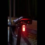 Moon Sport Helix Sense rear bike light with auto brightness and braking alert, featuring 150 lumens for safety visibility.