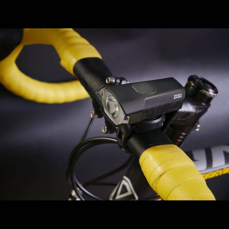 Moon Sport VELA 200lm front and ORION 50lm rear bike light set in black, mounted on a bicycle for visibility and safety.