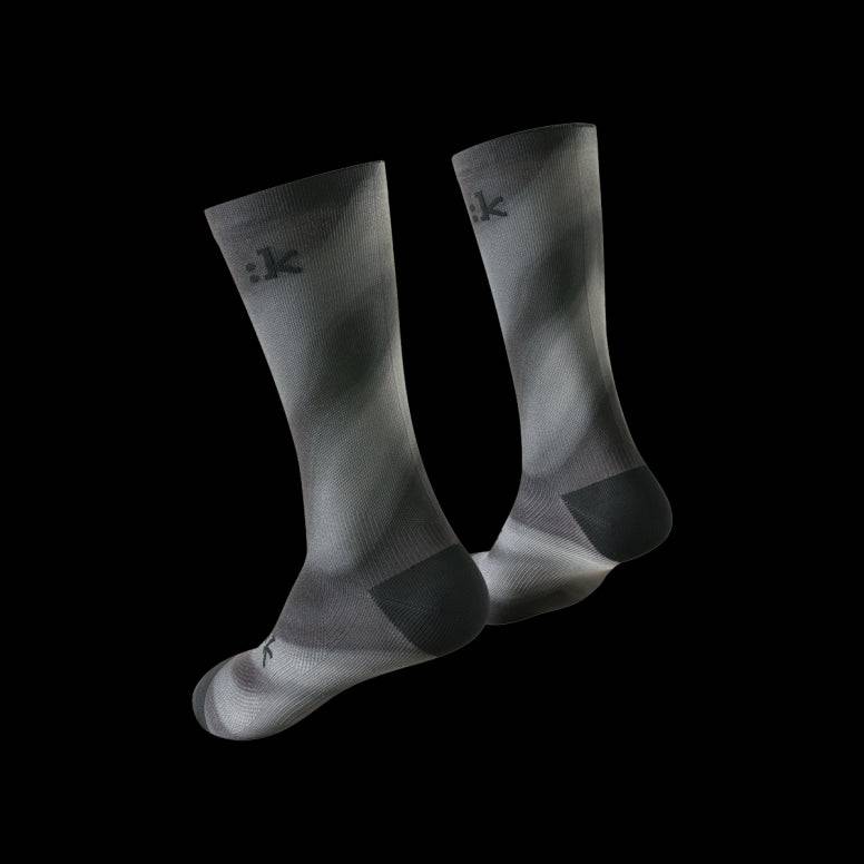 Fizik Fade cycling socks in black with colorful fade design, breathable and moisture-wicking performance clothing for cyclists.