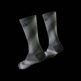 Fizik Fade cycling socks in black with colorful fade design, breathable and moisture-wicking performance clothing for cyclists.