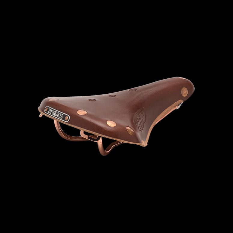 Brooks B17 Special short road bike saddle with copper steel rails and rivets, showing a close-up of the saddle's leather surface.