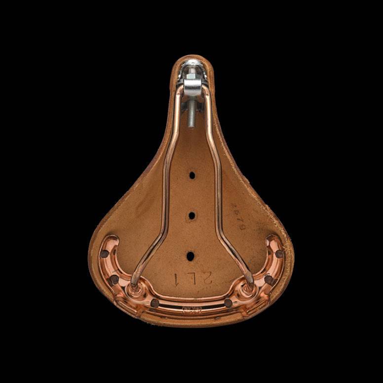 Brooks B17 Special short road bike saddle with copper steel rails and rivets, close-up view of saddle's leather surface and construction.