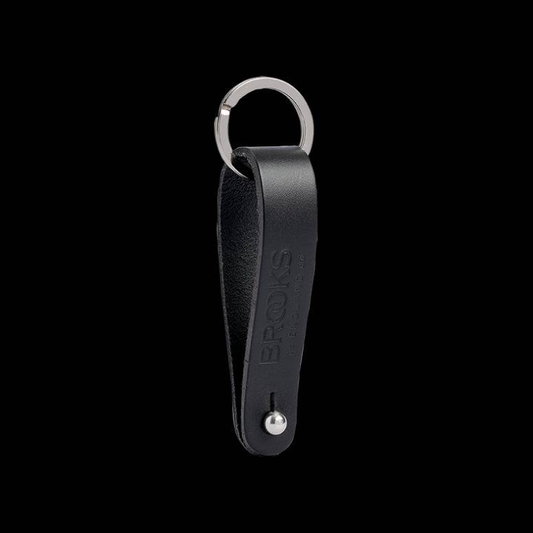 Brooks Hub Shiner leather bike hub cleaner and keychain accessory with leather strap and metal clasp, designed for bike maintenance.