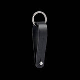 Brooks Hub Shiner leather bike hub cleaner and keychain accessory with leather strap and metal clasp, designed for bike maintenance.