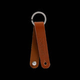 Brooks Hub Shiner Leather bike hub cleaner and keychain accessory, featuring leather and metal components with branding details.