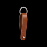 Brooks Hub Shiner leather bike hub cleaner and keychain accessory, featuring a compact design with leather accents and keyring attachment.