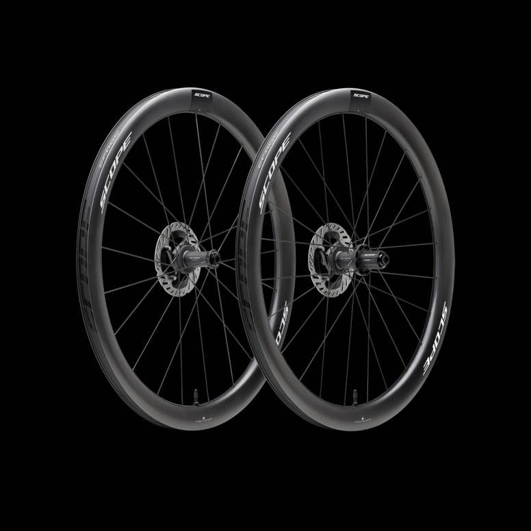 Scope Cycling R4 V2 45mm road wheelset with aerodynamic tubeless-ready wheels, mounted on a bike with visible spokes and rim profile.