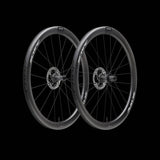 Scope Cycling R4 V2 45mm road wheelset with aerodynamic tubeless-ready wheels, mounted on a bike with visible spokes and rim profile.
