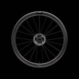 Scope Cycling R4.A V2 45mm allroad wheelset with tubeless-ready, aerodynamic design, shown on a bike component background.