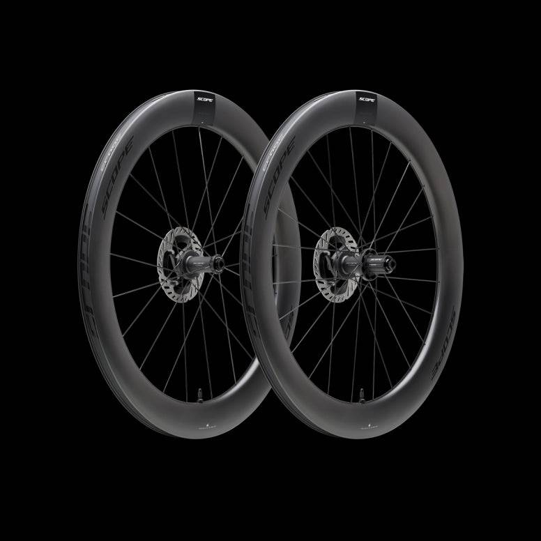 Scope Cycling R6 V2 65mm tubeless clincher road wheelset with aerodynamic racing design, shown in a close-up view of the component.