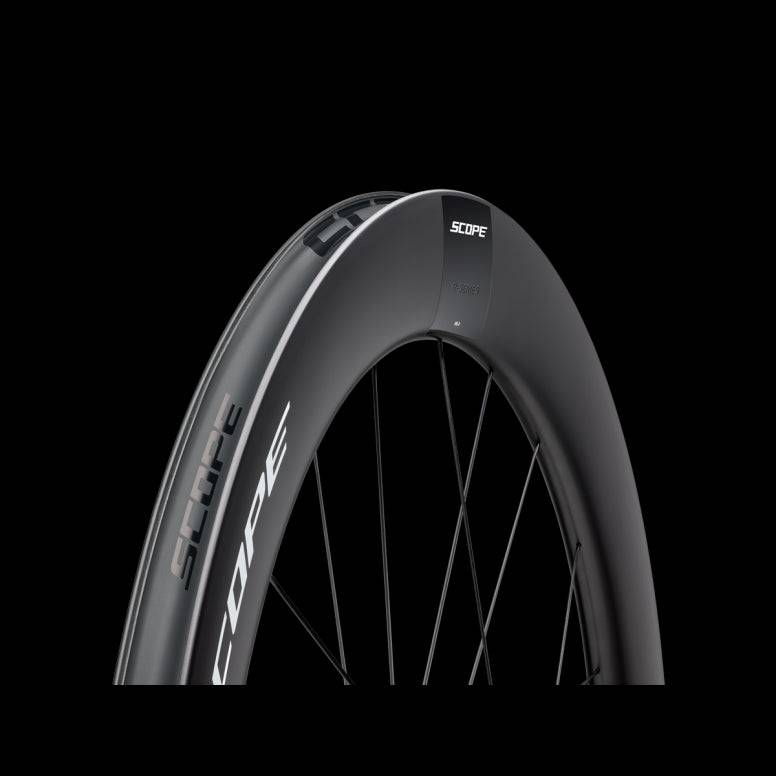 Scope Cycling R6.A V2 65mm allroad wheelset with tubeless-ready tires and aerodynamic design, shown installed on a bicycle.