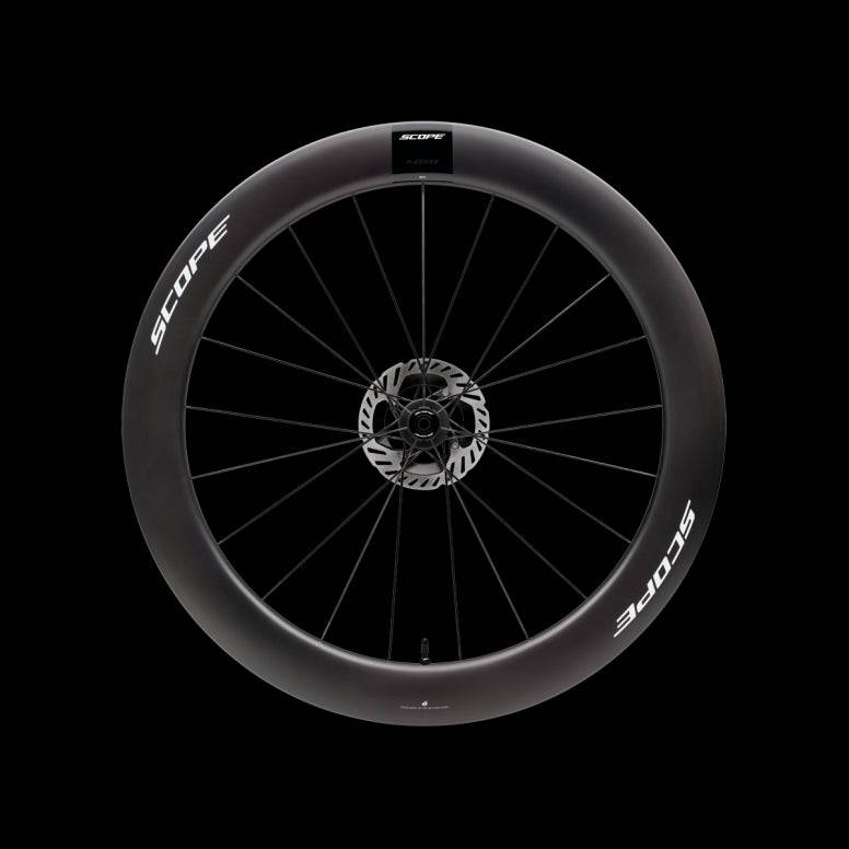 Scope Cycling R6.A V2 65mm allroad wheelset with tubeless-ready tires and aerodynamic design, shown with spokes and rims visible.