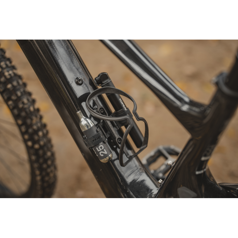 Topeak Cage Mount Side accessory for bottle cage accessories on e-bikes and mountain bikes, shown attached to bike frame.