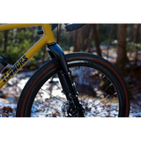Cane Creek Invert Cargo Mount for bikepacking forks with 3-bolt interface, showing the black mount attached to a bicycle fork