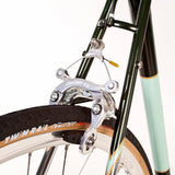 Light Blue St Johns retro road bike with Shimano Sora gears and Reynolds 725 frame, shown from side view.