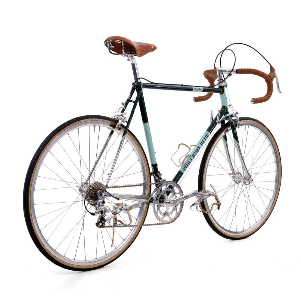 Light blue St Johns retro road bike with Shimano Sora components and Reynolds 725 frame, shown from side view.