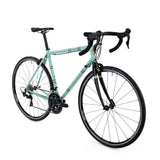 Light Blue Sport Wolfson 105 R7000 road bike featuring Shimano 105 drivetrain, lightweight frame, and aerodynamic design.