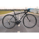Light Blue Wolfson Sora R3000 18-speed road bike with Shimano gears and Reynolds 853 steel frame, shown from side view.