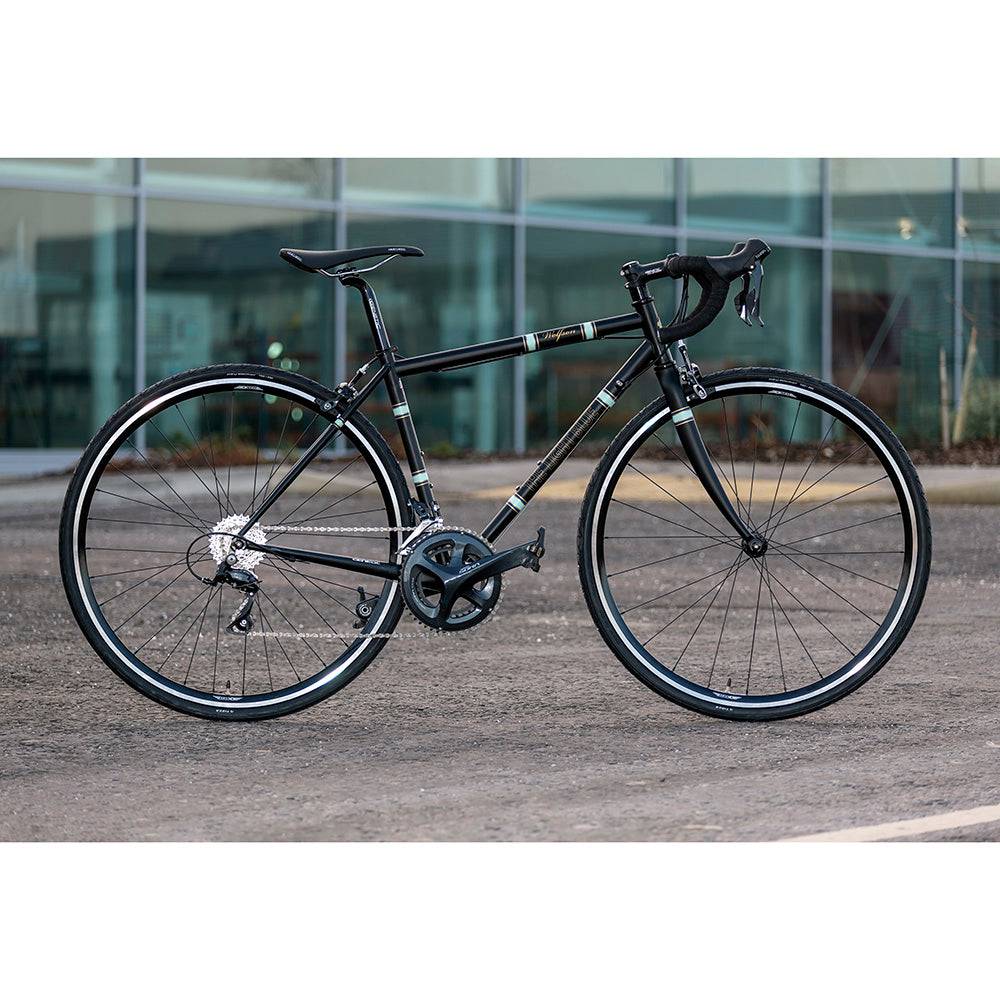Light Blue Sport Wolfson Sora R3000 18-speed road bike with Shimano gears and Reynolds 853 steel frame, shown in an outdoor setting.
