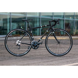 Light Blue Sport Wolfson Sora R3000 18-speed road bike with Shimano gears and Reynolds 853 steel frame, shown in an outdoor setting.