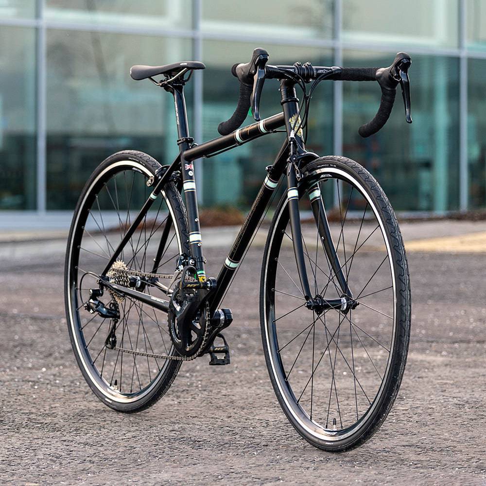 Light Blue Sport Wolfson Sora R3000 18-speed road bike with Shimano gears and Reynolds 853 steel frame, shown in profile.