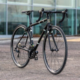 Light Blue Sport Wolfson Sora R3000 18-speed road bike with Shimano gears and Reynolds 853 steel frame, shown in profile.
