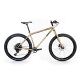 Surly Karate Monkey 27.5+ trail hardtail mountain bike frame in gold, designed for versatile mountain biking performance.