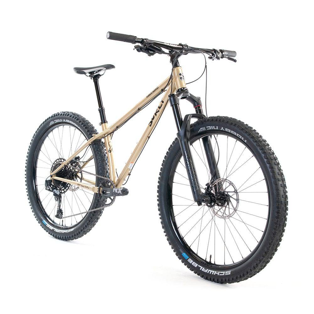Surly Karate Monkey 27.5+ suspension mountain bike frame with gold finish and Boost hub compatibility, shown from side view.
