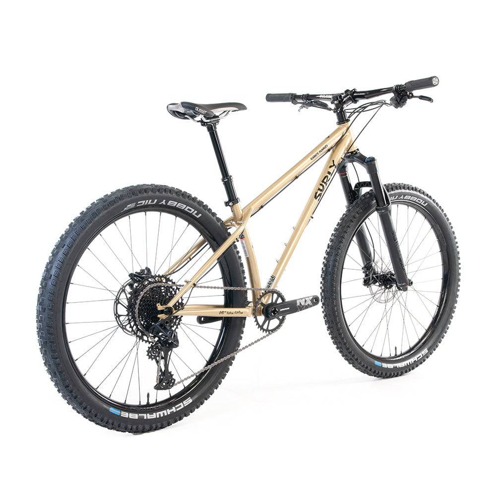 Surly Karate Monkey 27.5+ suspension mountain bike frame with boost hub compatibility, shown in gold color.