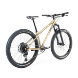 Surly Karate Monkey 27.5+ suspension mountain bike frame with boost hub compatibility, shown in gold color.