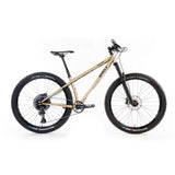 Surly Karate Monkey 27.5+ suspension mountain bike frame with gold finish, boost hub compatibility, and durable steel construction.