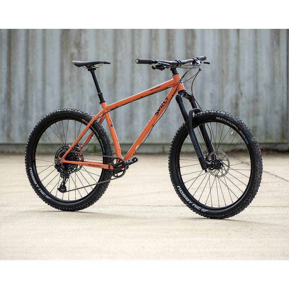 Surly Karate Monkey 27.5+ suspension mountain bike frame with boost hub compatibility, shown in a natural outdoor setting.