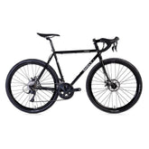 Black Surly Straggler 650b Sora gravel bike with steel frame, equipped for commuting and touring, featuring drop handlebars and knobby tires.