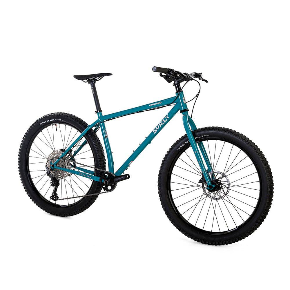 Surly Karate Monkey 27.5+ mountain bike frame with Deore drivetrain, blue frame and detailed components, ready for off-road riding.