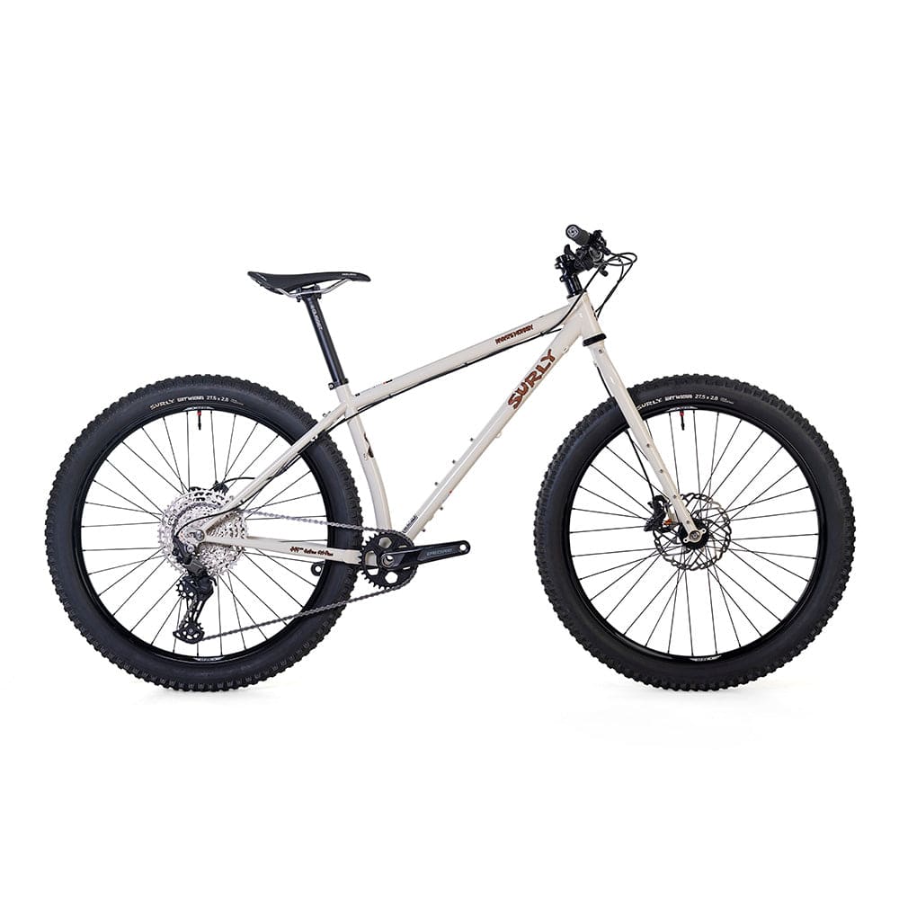 Surly Karate Monkey 27.5+ mountain bike frame with Deore drivetrain, featuring a white frame and rugged mountain bike design.