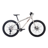 Surly Karate Monkey 27.5+ mountain bike frame with Deore drivetrain, featuring a white frame and rugged mountain bike design.