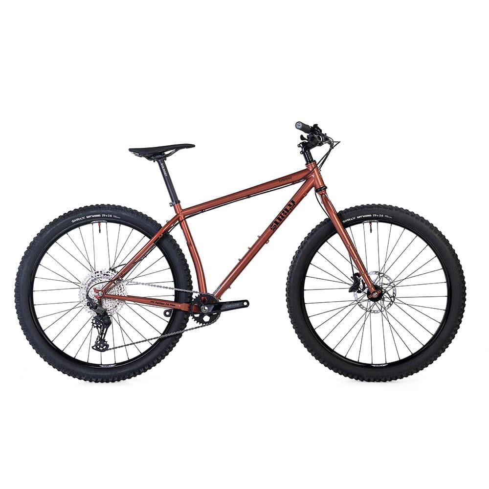 Copper Surly Krampus Deore 29er mountain bike with agile trail geometry, featuring knobby tires and suspension for off-road riding.
