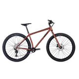 Copper Surly Krampus Deore 29er mountain bike with agile trail geometry, featuring knobby tires and suspension for off-road riding.