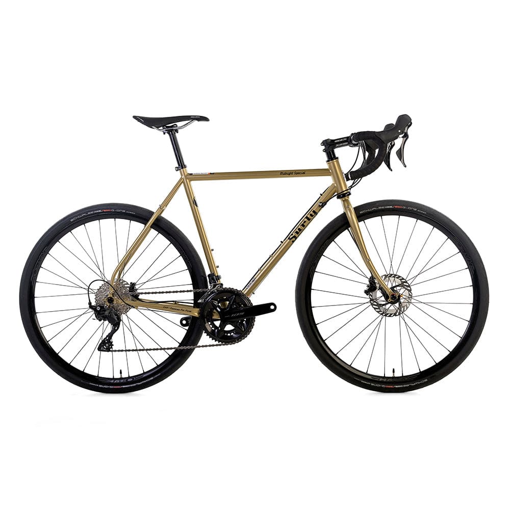 Surly Midnight Special 105 700c road plus bike with gold frame, designed for pavement and gravel riding.