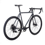 Surly Straggler 1x gravel bike with a dark blue steel frame, suitable for commuting, touring, and gravel riding.